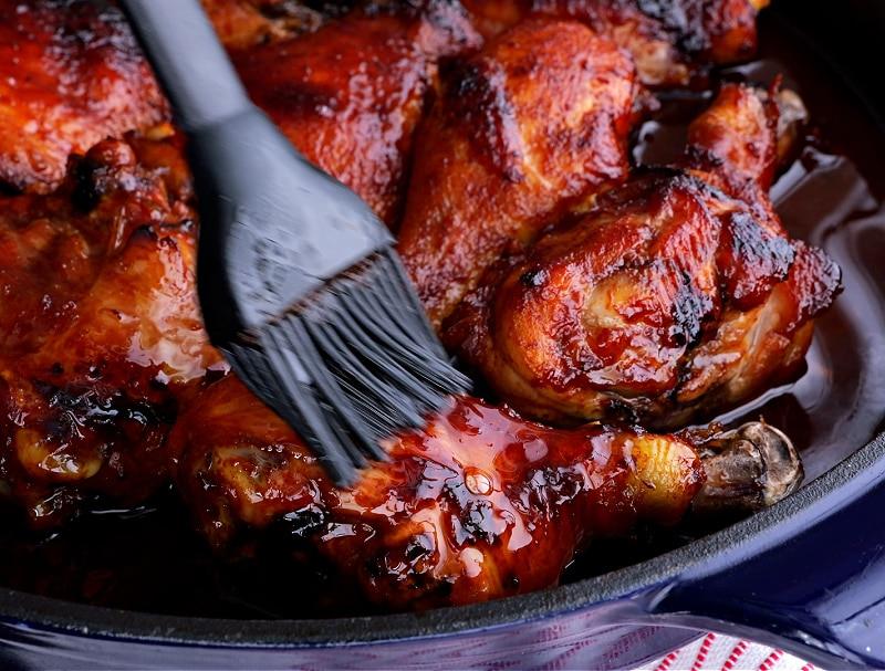 Brushing chicken with glaze.