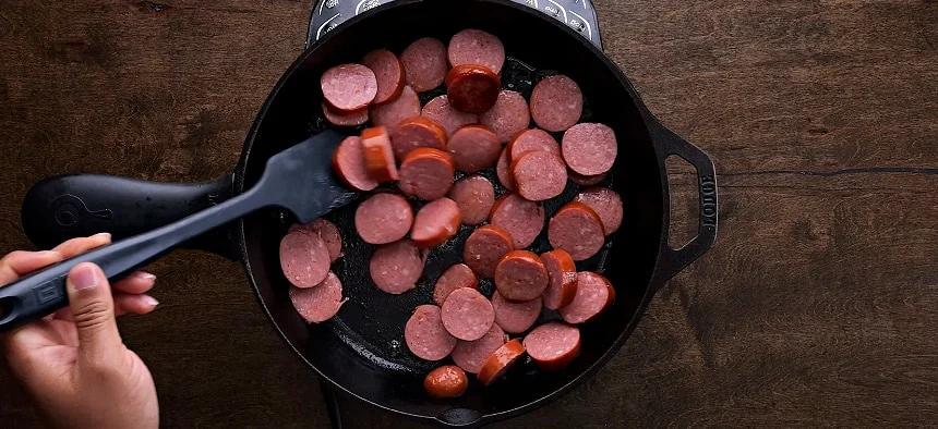 Browning the sausage in a skillet.