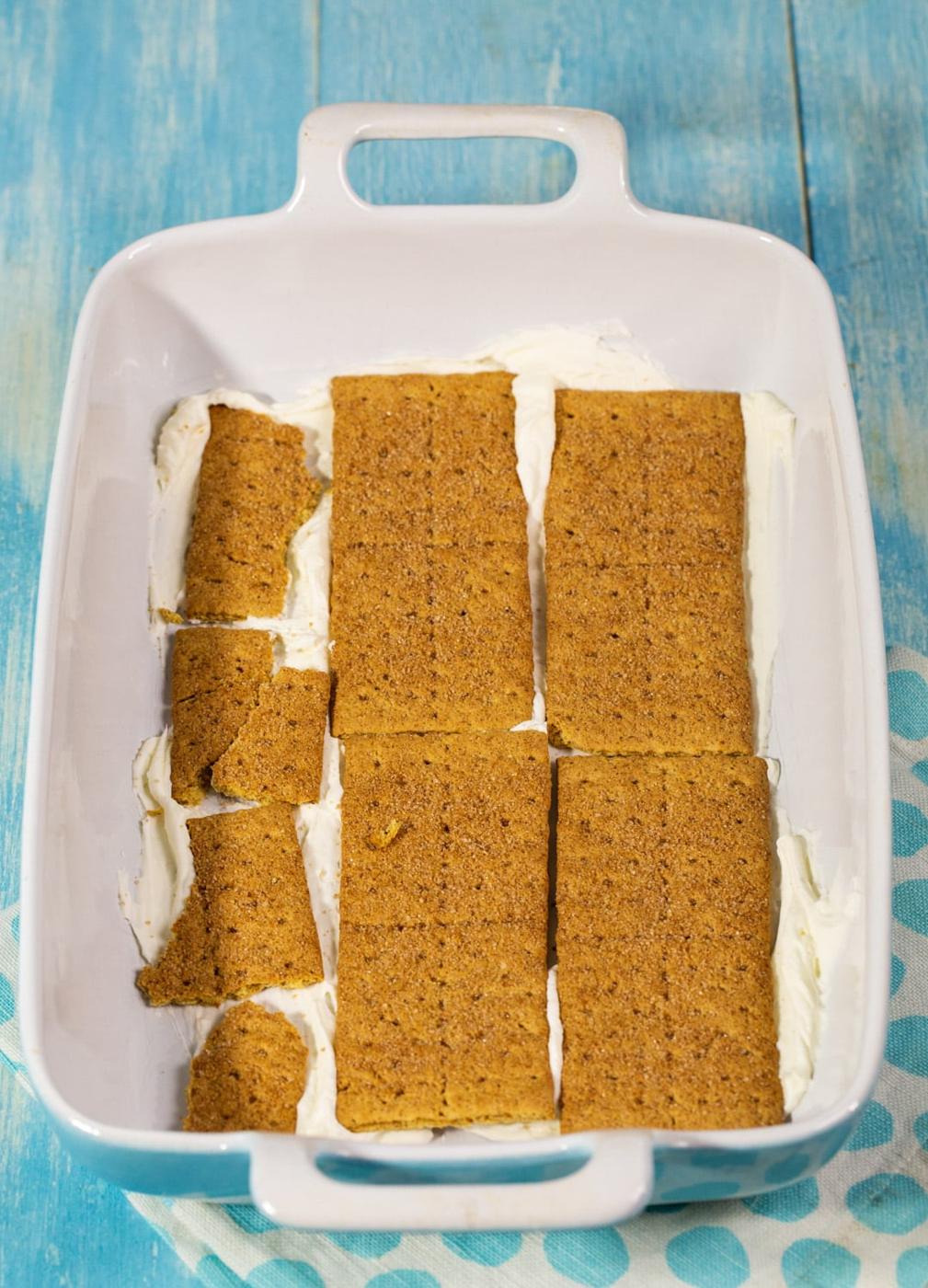 Layer of graham crackers in baking dish.