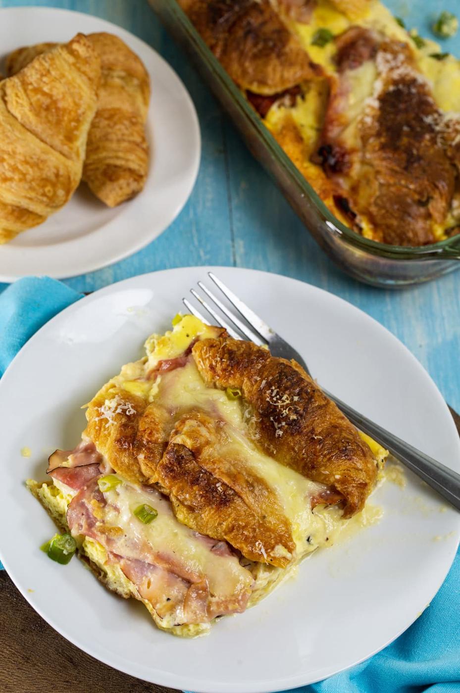 Stuffed Ham and Cheese Croissant Casserole on a plate and plate of croissants.