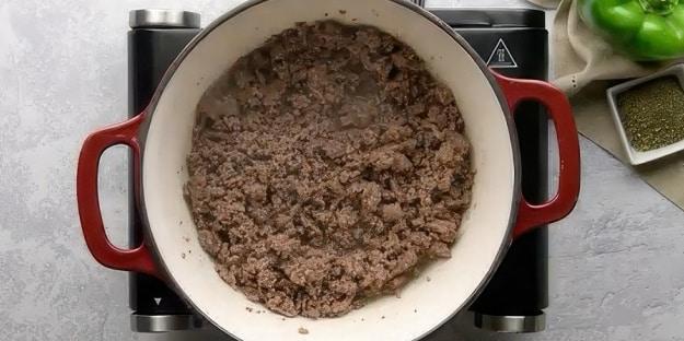 Browned ground beef in Dutch oven.