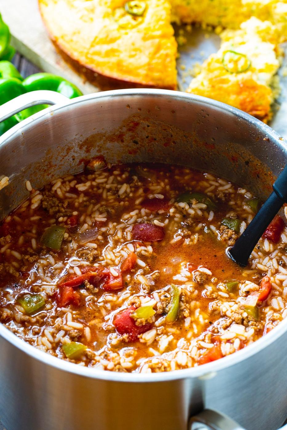Pot full of Stuffed Pepper Soup with cornbread.