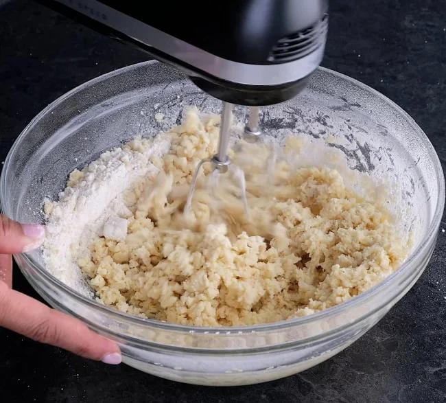 Mixing flour into dough.