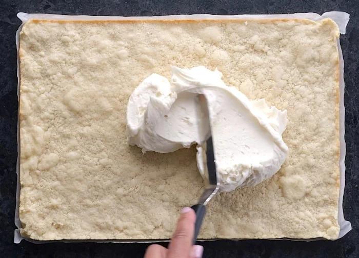 Spreading frosting on.