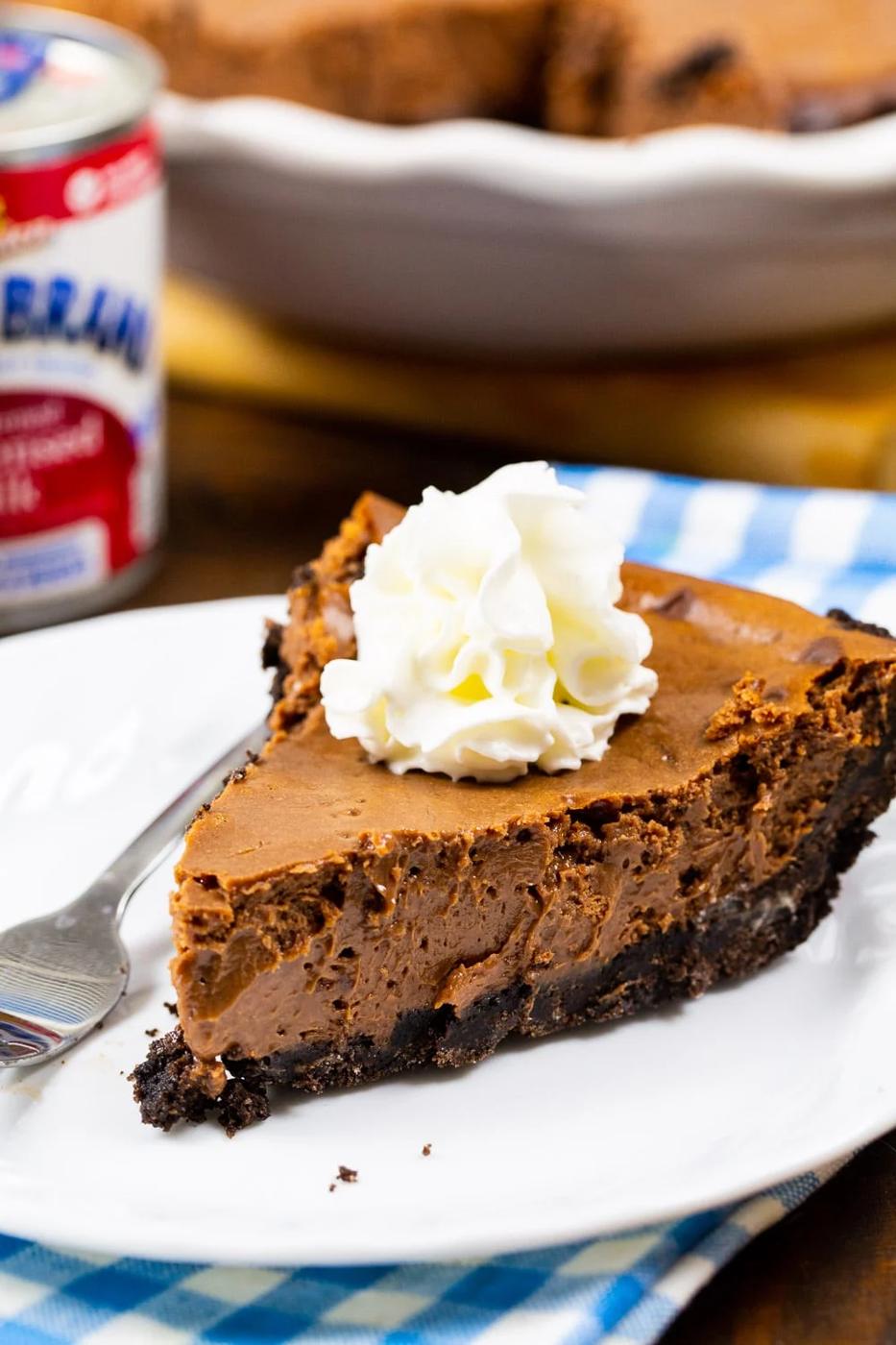 Slice of Sweetened Condensed Milk Chocolate Pie topped with whipped cream.