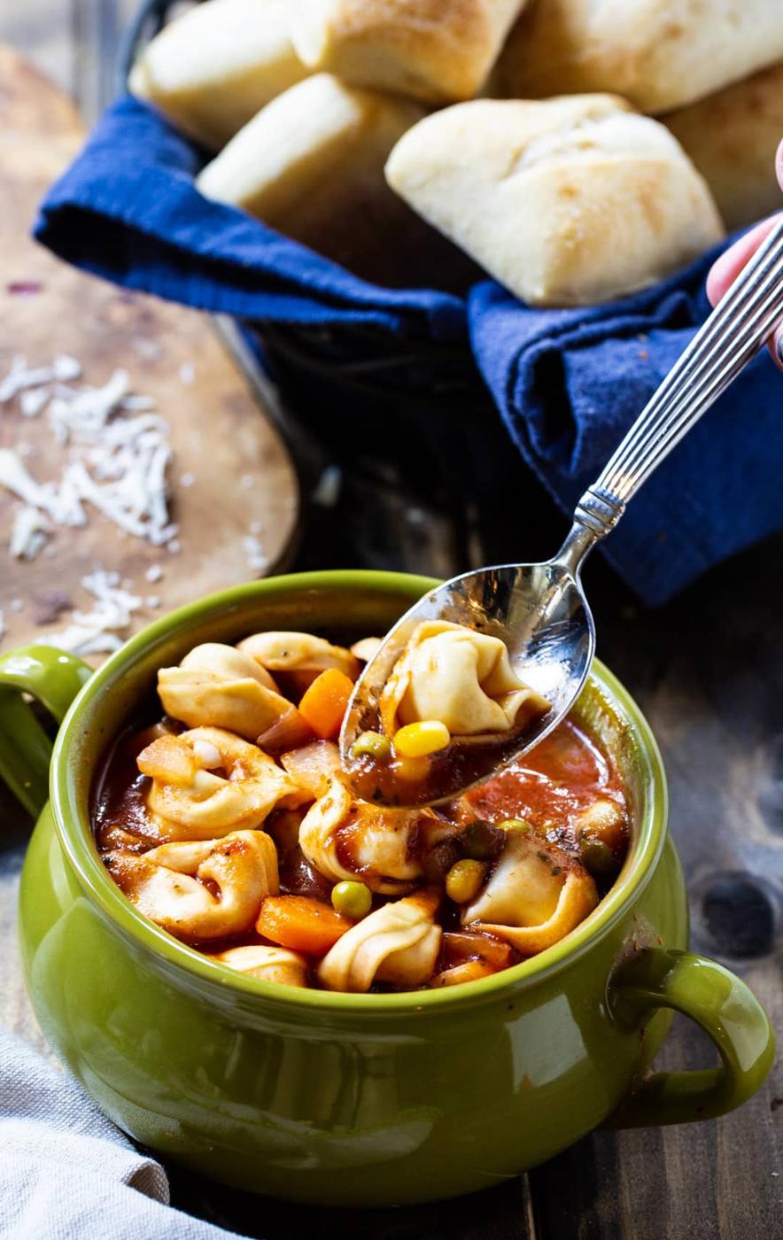 Spoon going into bowl of soup.