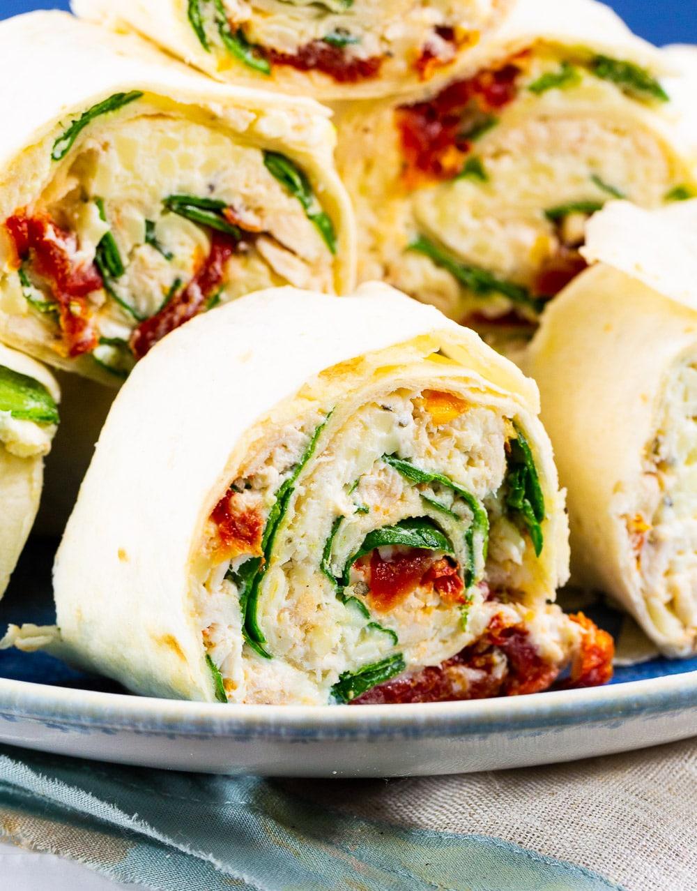 Close-up of a pinwheel filled with Tuscan chicken mixture.