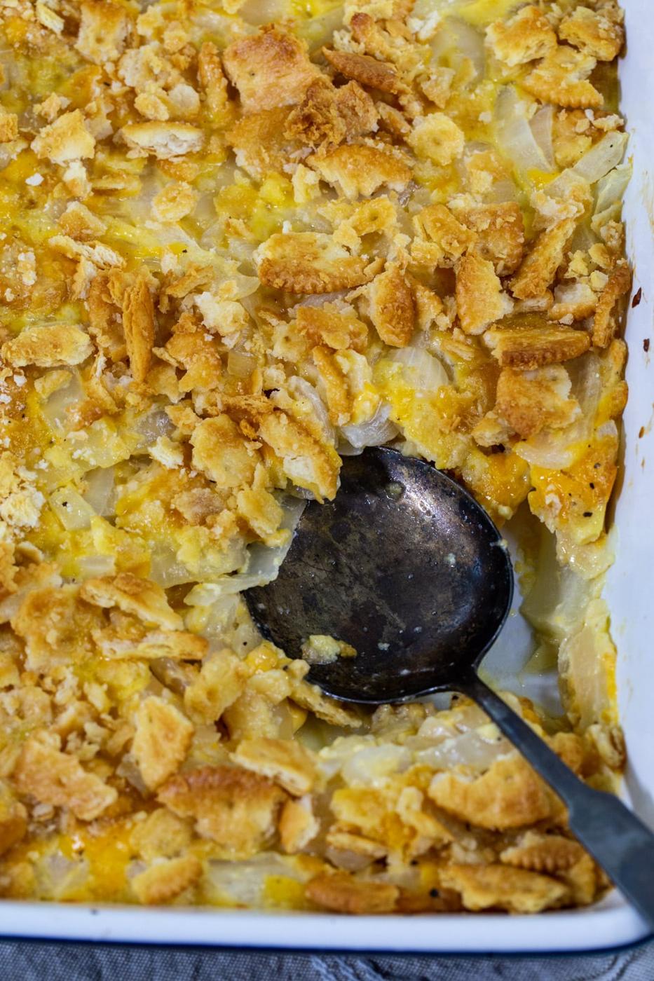 Spoon scooping up casserole.