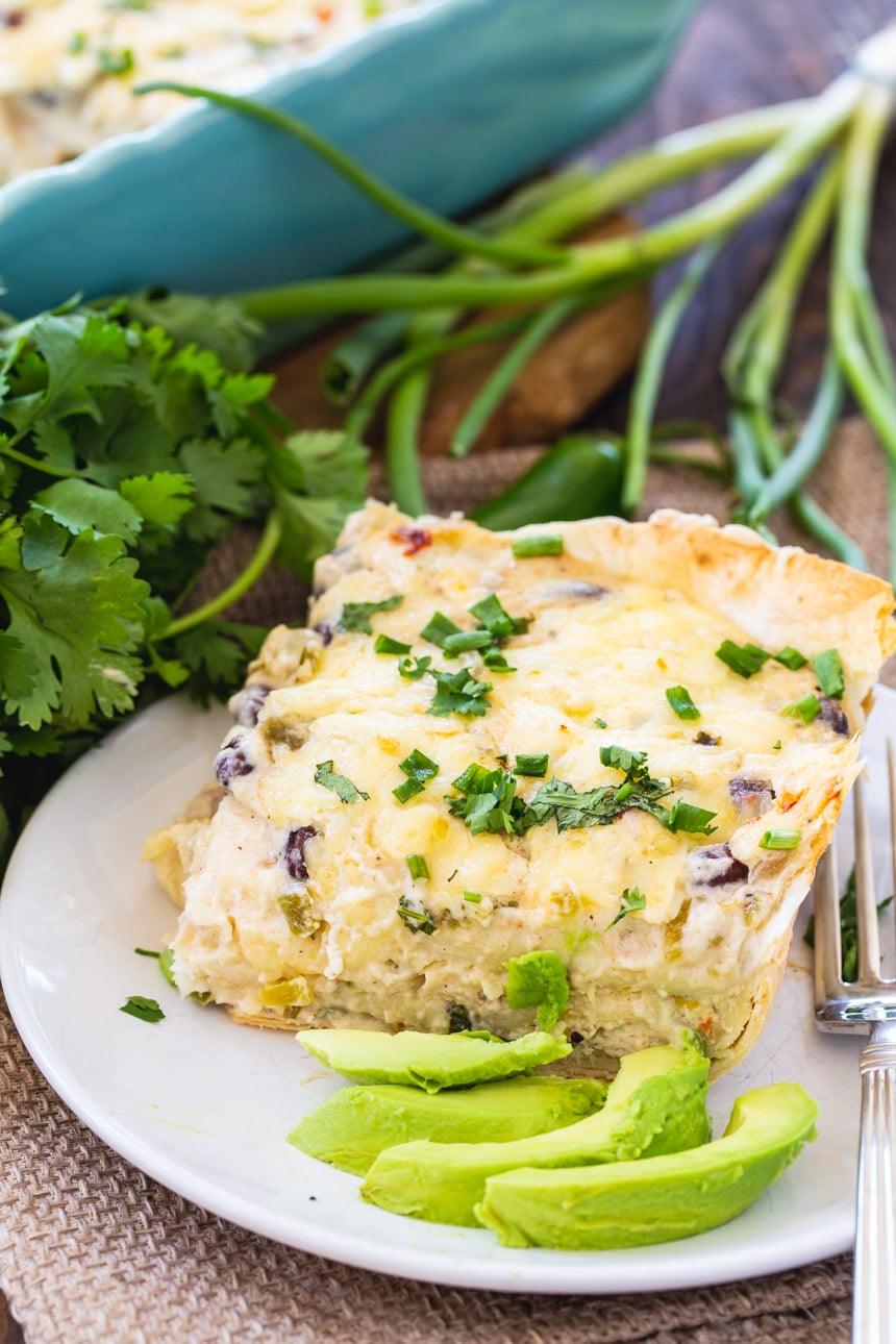 White Chicken Enchilada Casserole with sliced avocado