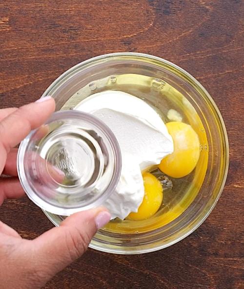 Mixing eggs and sour cream.