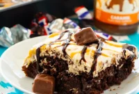 Loaded Snickers Poke Cake