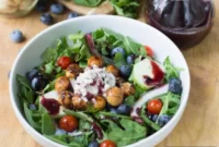 Peppery Arugula with Blueberry Drizzle and Spiced Macadamia Crunch