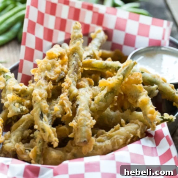 Crunchy Green Bean Fries 2 A plate of golden-brown crispy fried green beans ready to be served.