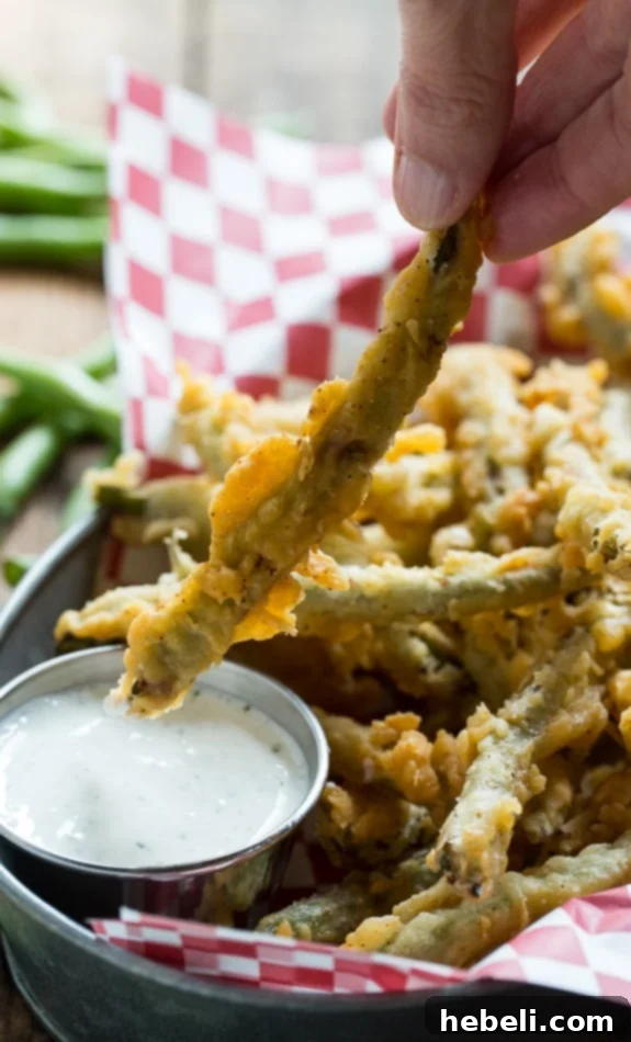 A closer look at the double-coated fried green beans, golden and ready to serve.