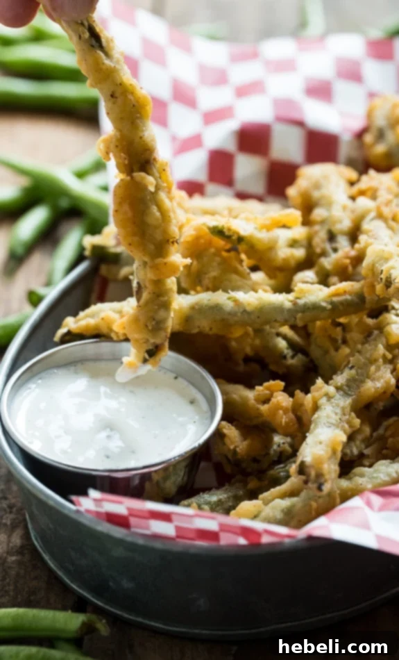 Crunchy Green Bean Fries 7 Appetizing photo of double-dipped fried green beans on a serving plate.