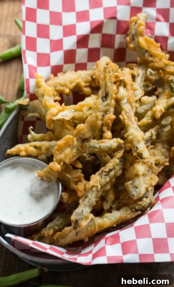 Crunchy Green Bean Fries 8 A vibrant plate of double-dipped fried green beans, perfectly cooked and seasoned.