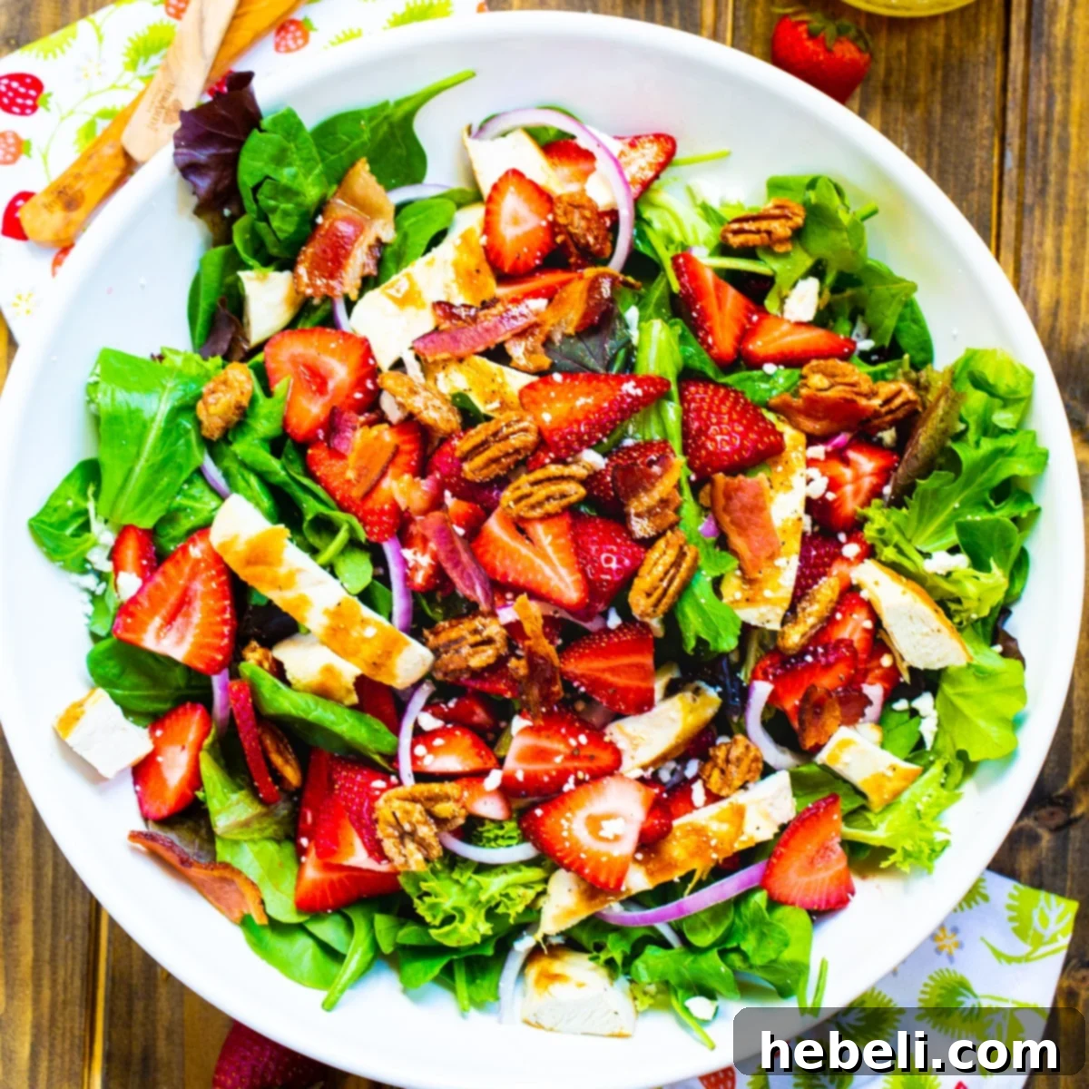 Strawberry Fields Salad in a large white serving bowl, showcasing its colorful ingredients.