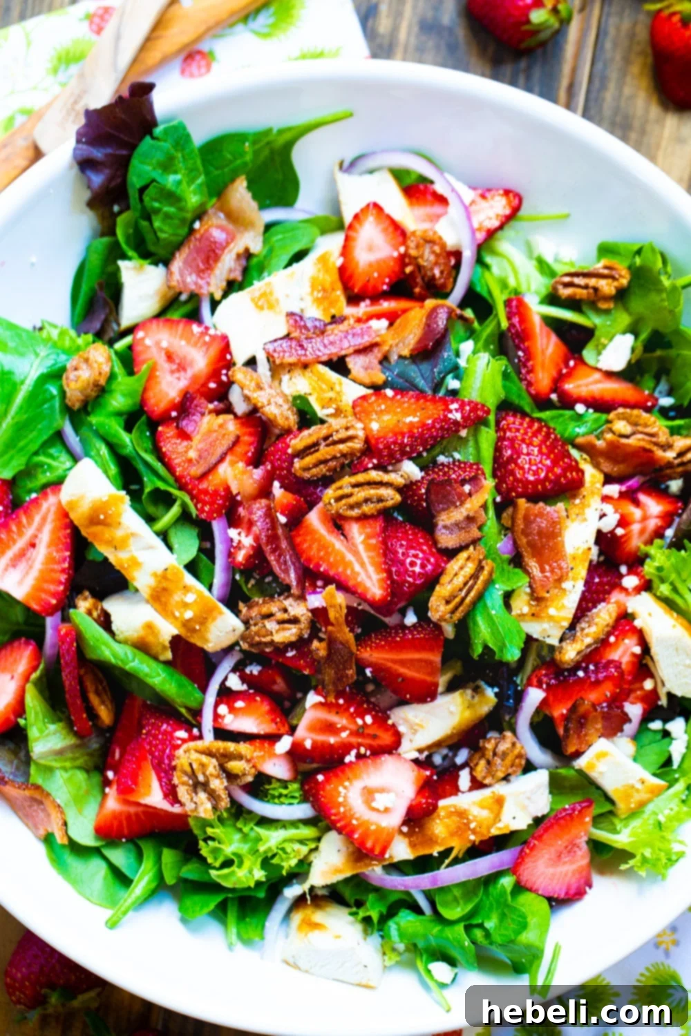 Overhead view of Strawberry Fields Salad in a white bowl, ready to be served.