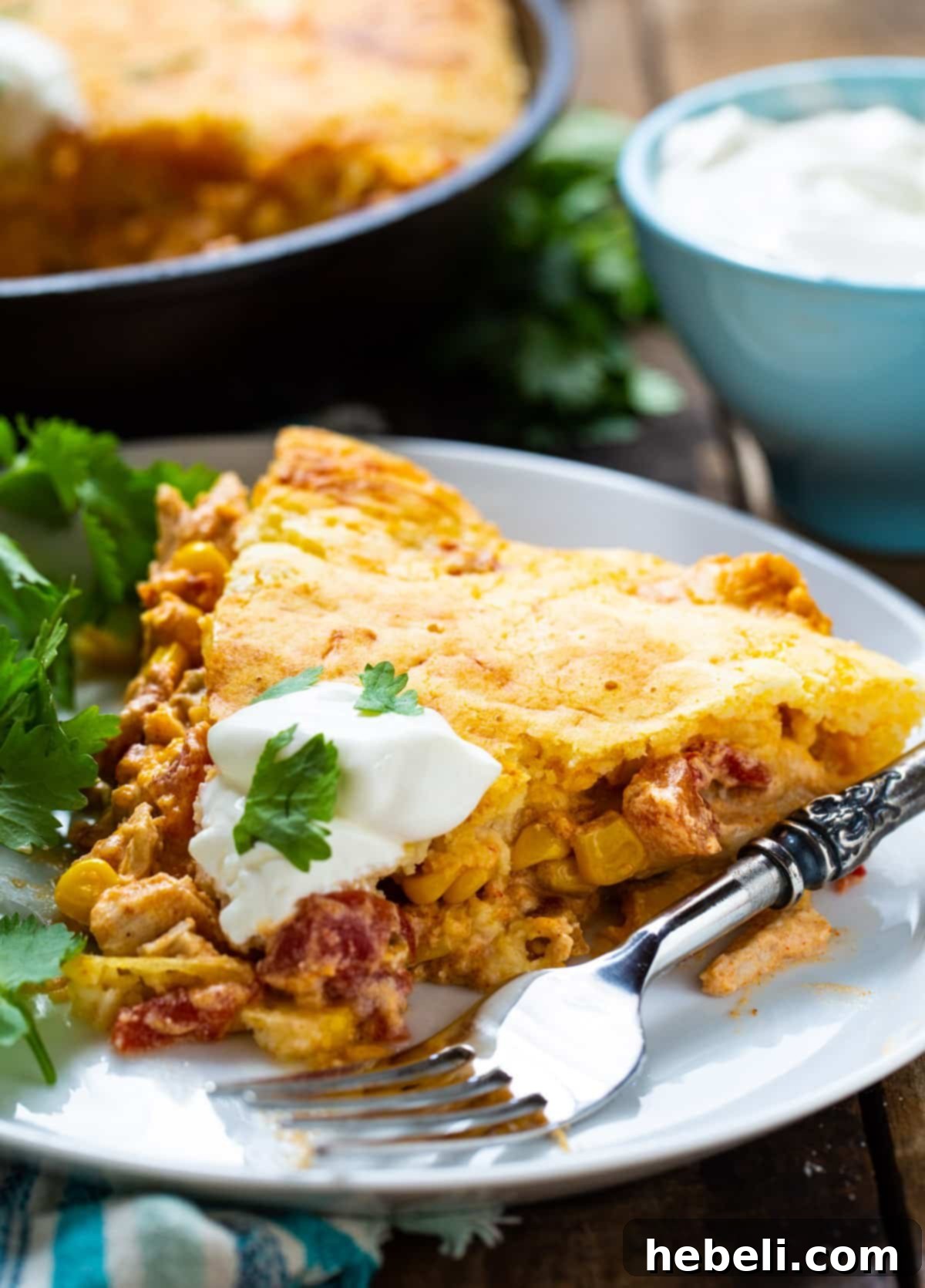 A perfectly portioned slice of Mexican Chicken Cornbread Casserole on a plate, showing the layers of filling and cornbread.