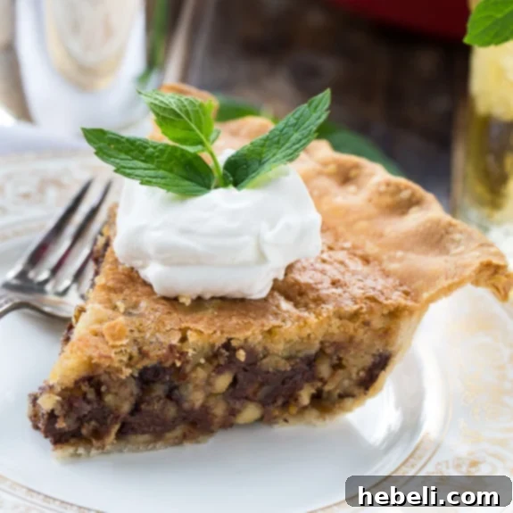 Classic Kentucky Derby Pie with a rich chocolate and walnut filling, finished with a generous dollop of bourbon whipped cream.