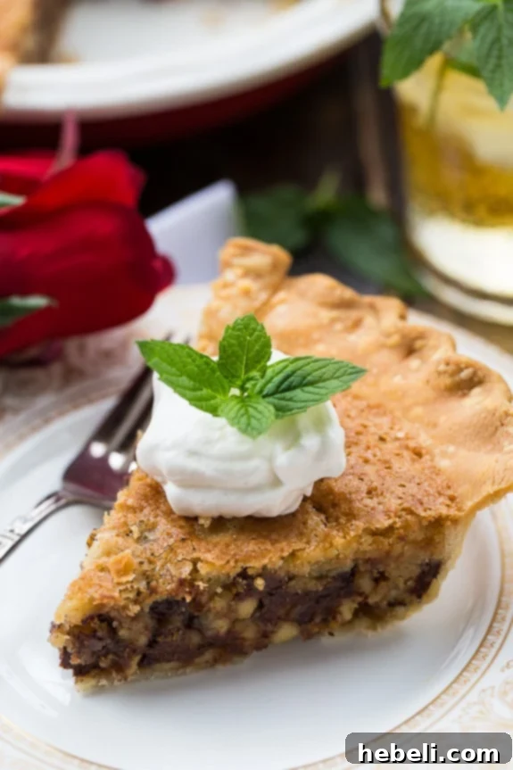 A slice of Kentucky Derby Pie with bourbon whipped cream on a plate, ready to be enjoyed.
