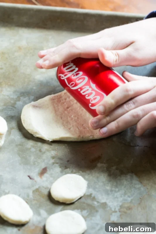 Hands preparing biscuit dough for fritters