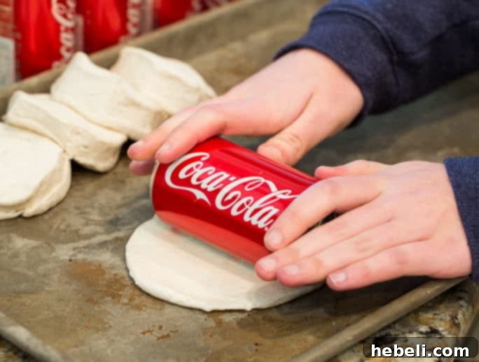 Using a mini Coca-Cola can to roll out biscuit dough