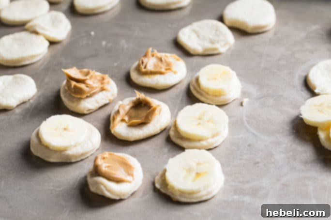 Adding banana slices and peanut butter to biscuit dough circles