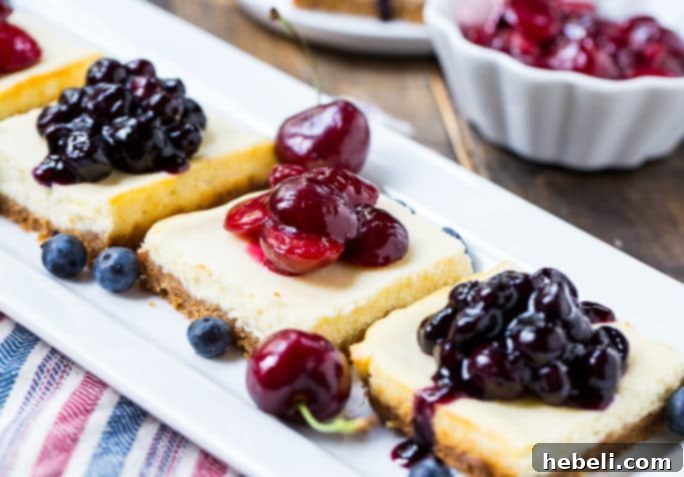 A delightful selection of Lightened-Up Cheesecake Bars, beautifully arranged to highlight the fresh fruit toppings and appealing presentation.