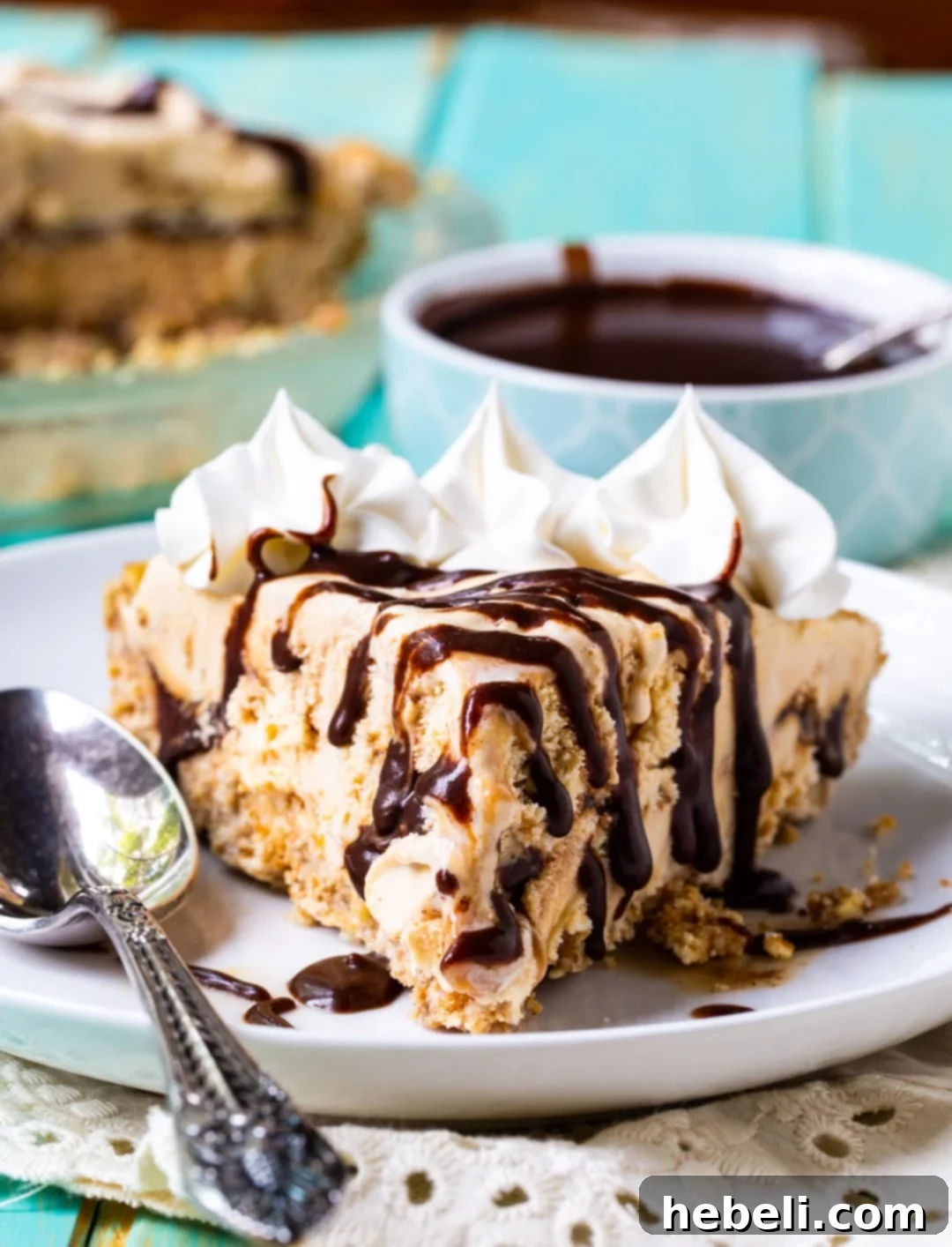 A close-up shot of a slice of the ice cream pie, beautifully layered with the golden dulce de leche ice cream and dark mocha fudge sauce, ready to be enjoyed.