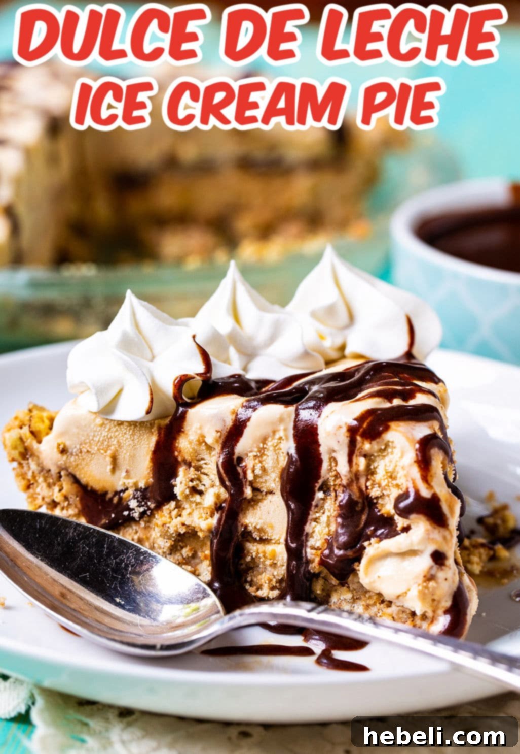 A beautifully presented slice of Dulce de Leche Ice Cream Pie, showing its layers and rich topping, served on a modern plate with a dessert spoon.