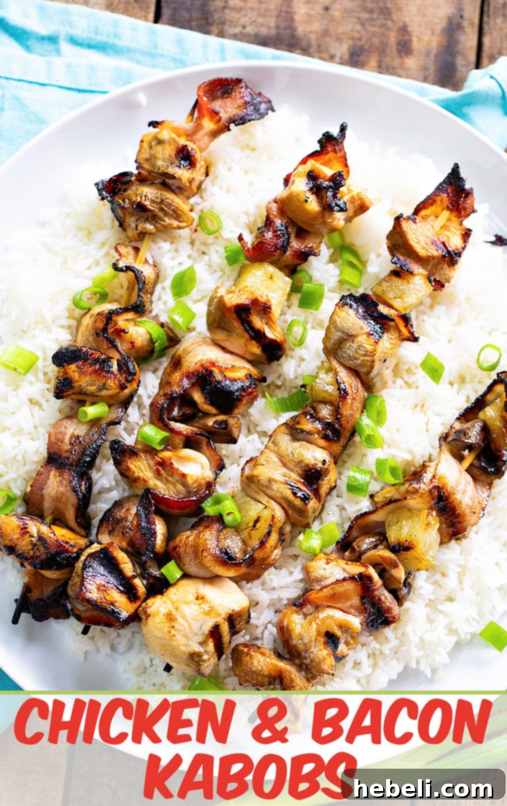 Grilled Chicken and Bacon Skewers 4 A close-up of a serving plate featuring Chicken and Bacon Kabobs over white rice, highlighting the glossy marinade and golden grilled components.