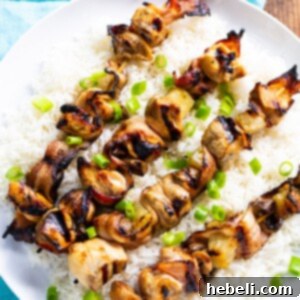 A vibrant image of a cooked Chicken and Bacon Kabob, featuring the crispy bacon, grilled chicken, and caramelized pineapple, ready for serving.