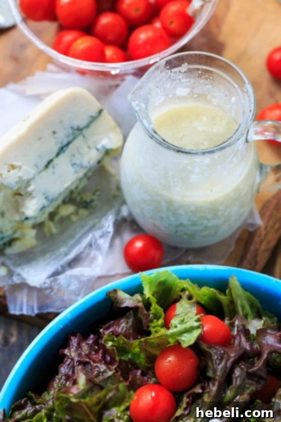 Close-up of Blue Cheese Vinaigrette in a glass jar, showing blue cheese crumbles