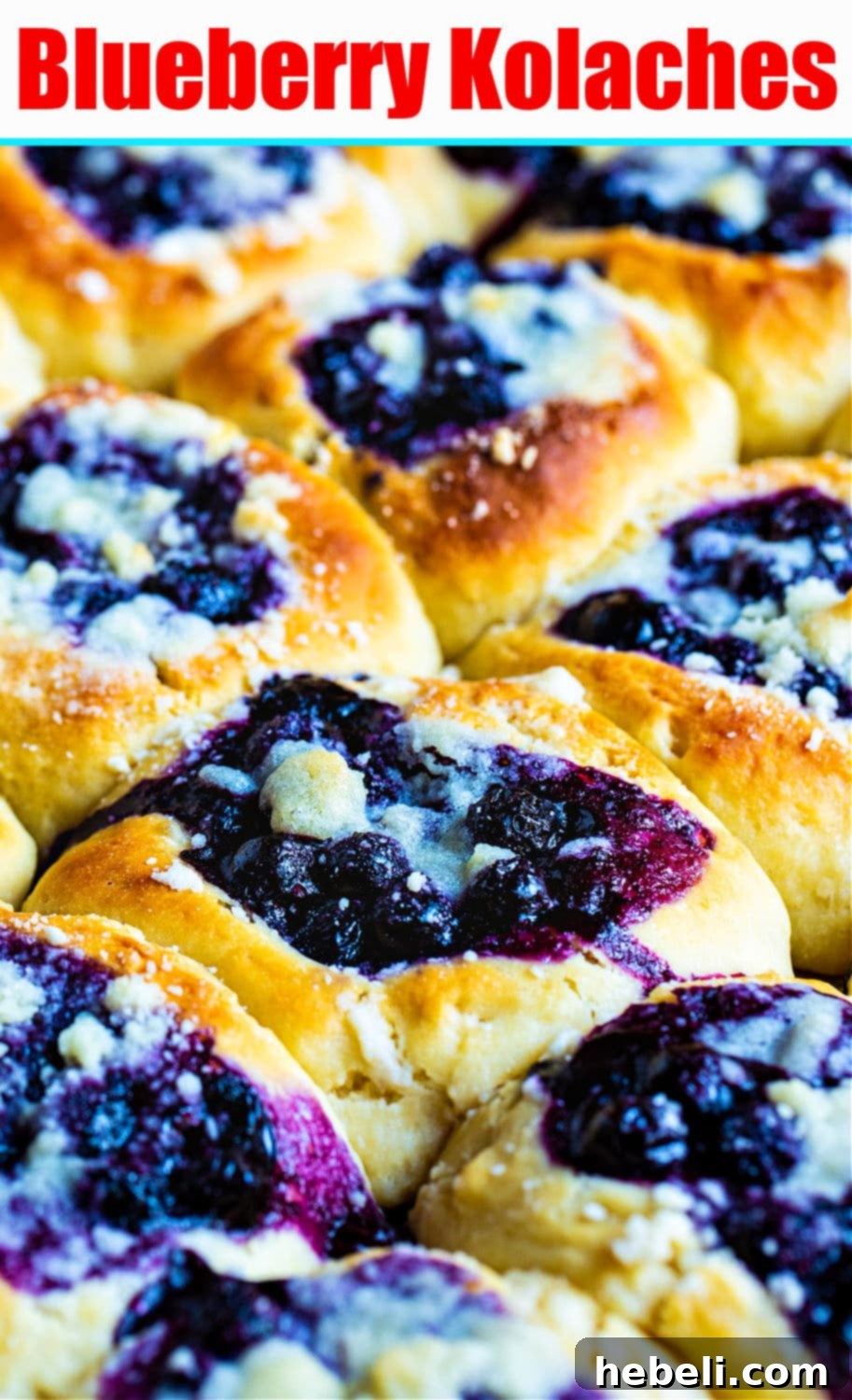 Bursting Blueberry Kolaches 8 Beautifully arranged Blueberry Kolaches on a wooden surface, highlighting their homemade appeal and delicious streusel.