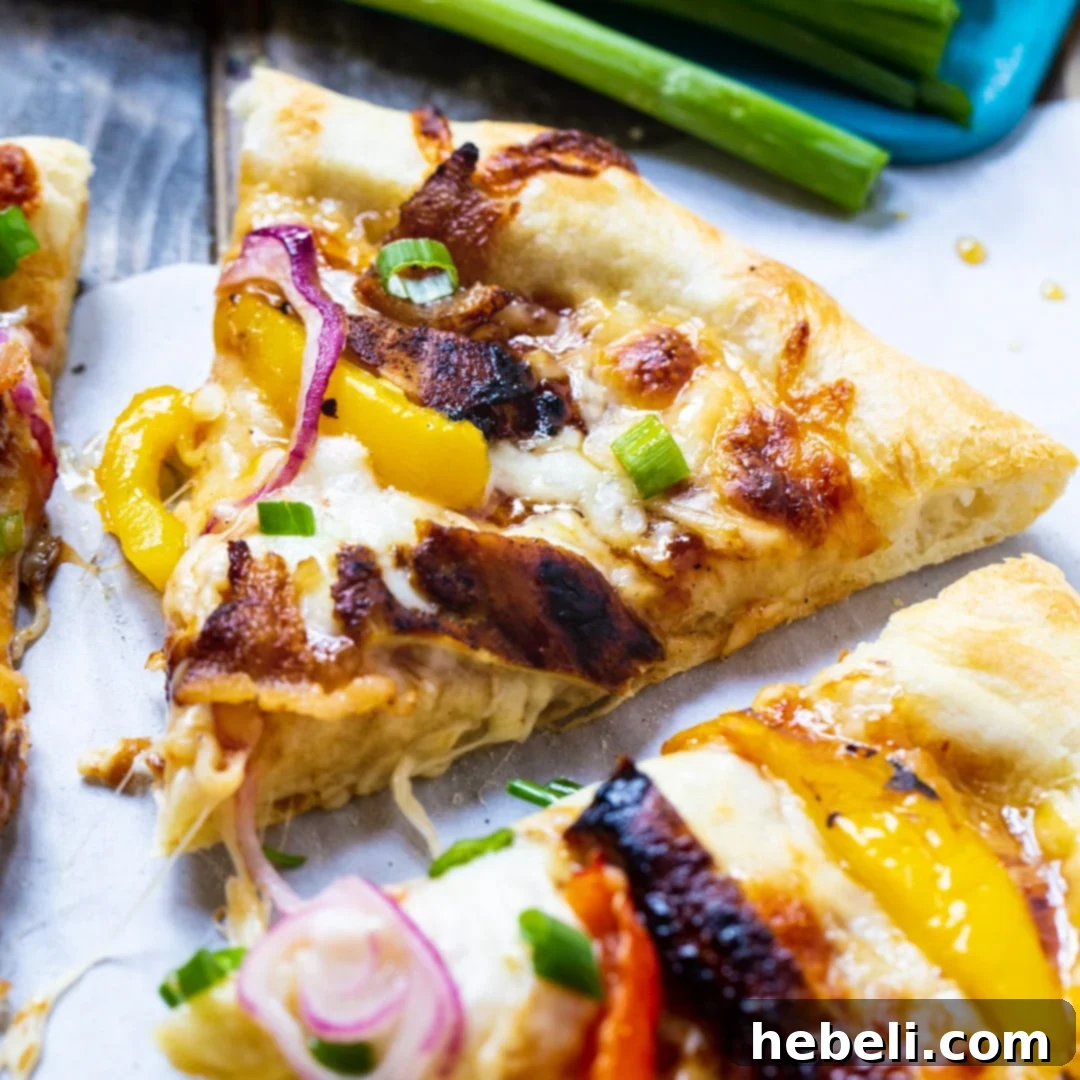 Slice of Jamaican Jerk Chicken Pizza with vibrant toppings