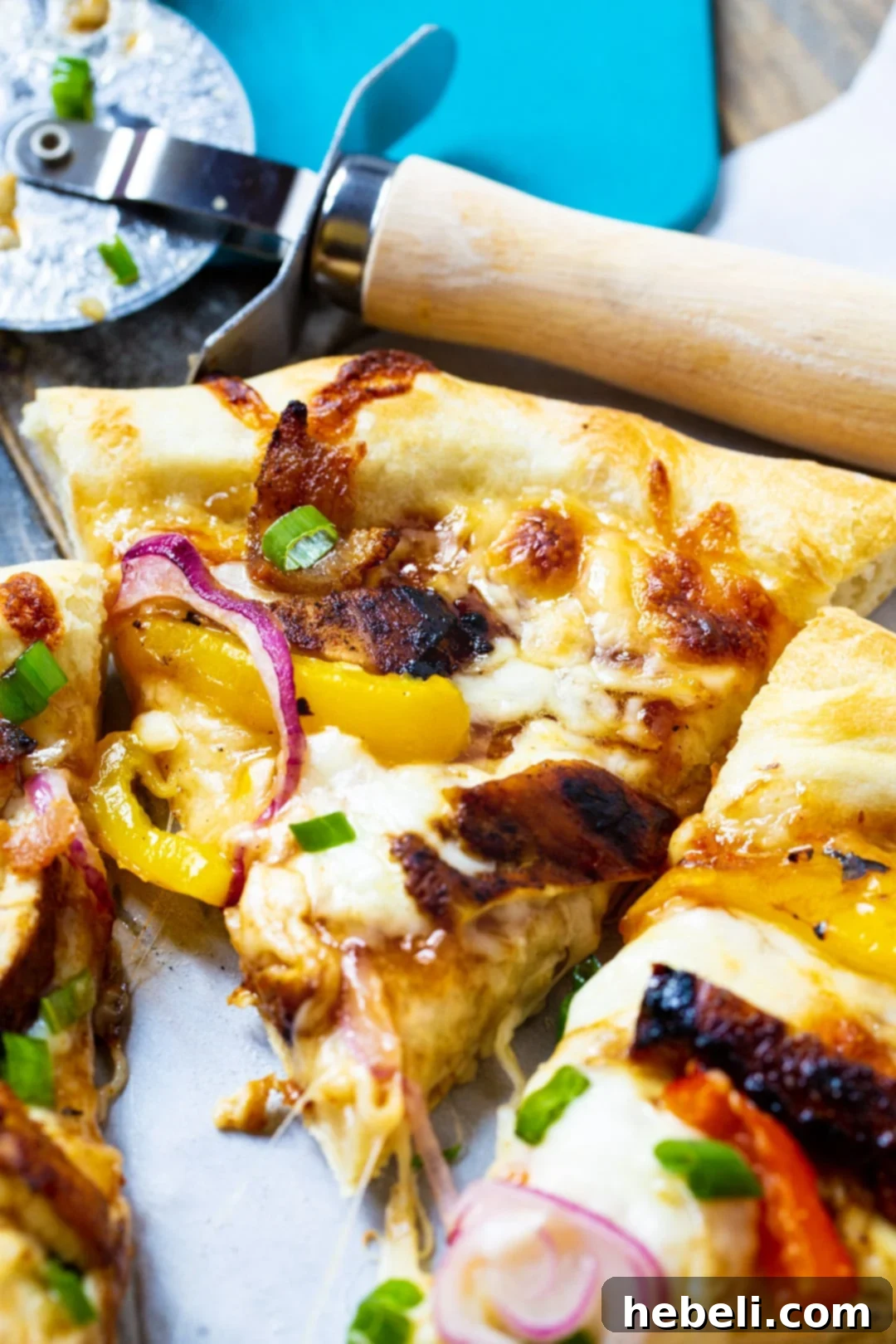 Close-up of a slice of Jamaican Jerk Chicken Pizza, showing rich toppings