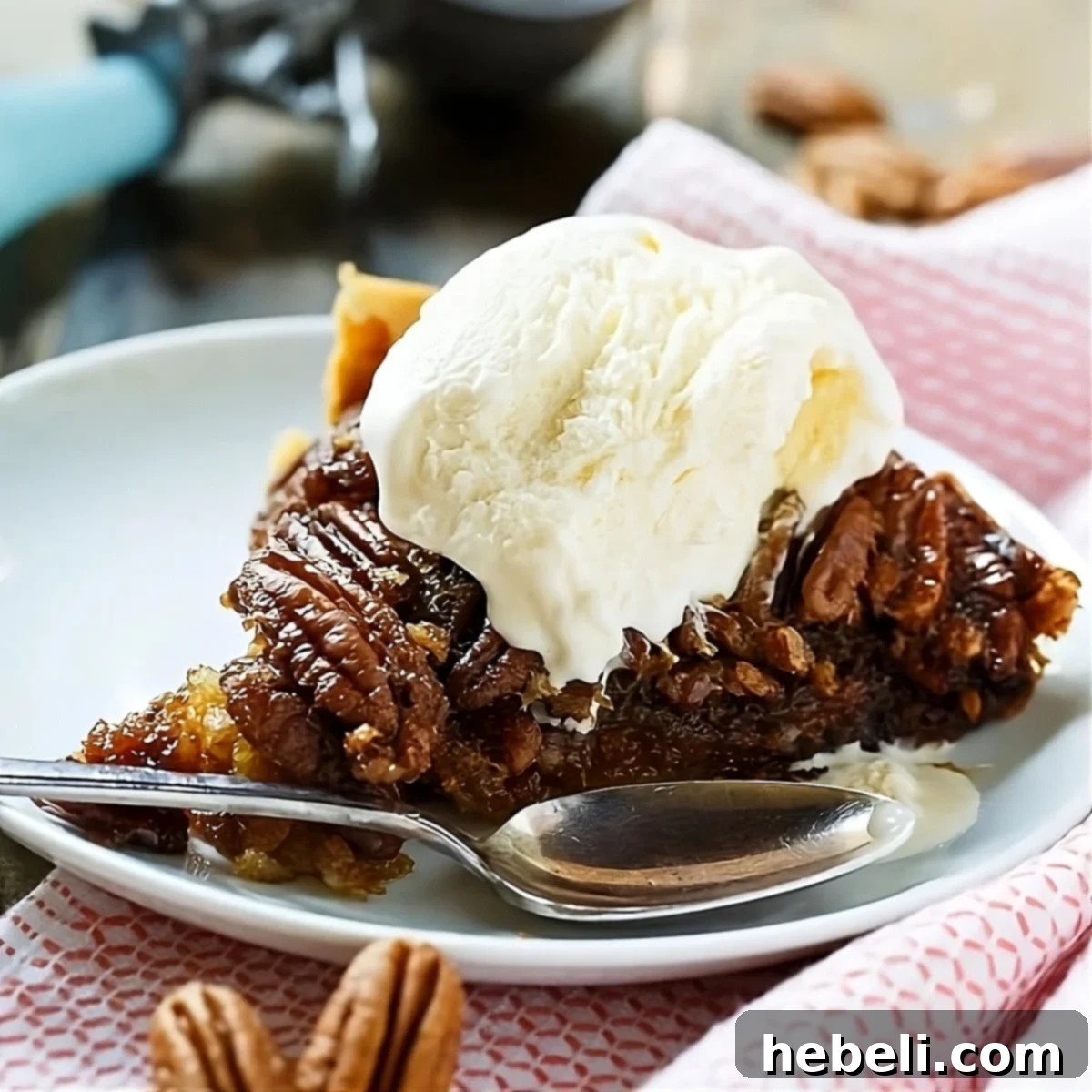 A perfectly baked slice of Crock Pot Pecan Pie, generously topped with a scoop of creamy vanilla ice cream, ready to be enjoyed.