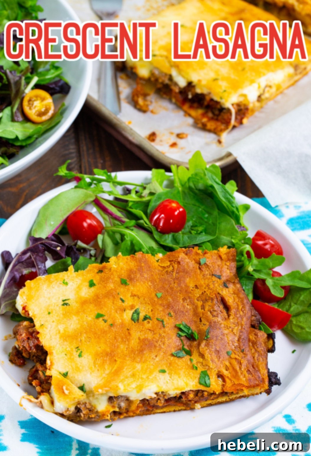 Close-up of a perfectly cooked slice of Crescent Lasagna, showing the golden crust, rich meat sauce, and creamy cheese layers, served on a plate.