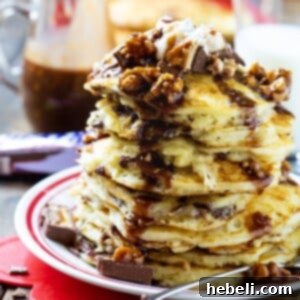 Stack of Snickers Pancakes on a plate.