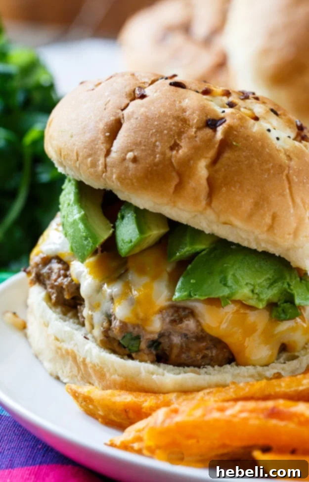 Smoky Chipotle Pork Burgers 4 Chipotle Pork Burgers being assembled with toppings