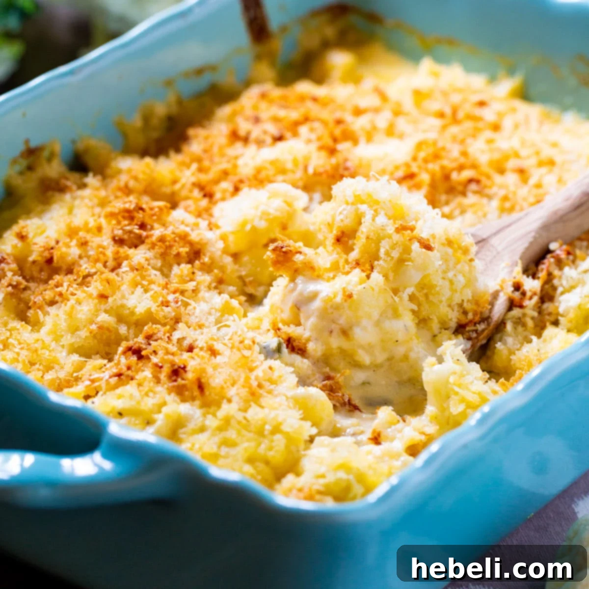 Velvety Cauliflower Mash 2 Creamed Cauliflower in a beautiful blue baking dish, garnished and ready to serve, a truly decadent side.