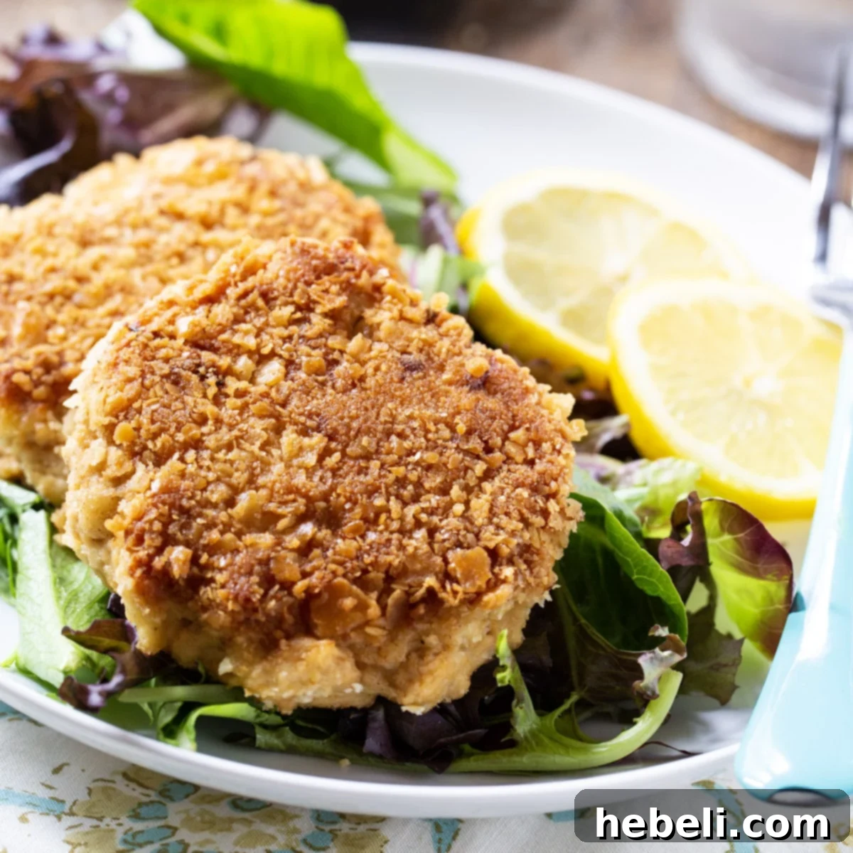Classic Southern Salmon Cakes 2 Crispy Southern Salmon Patties on a bed of fresh lettuce, ready to be served.