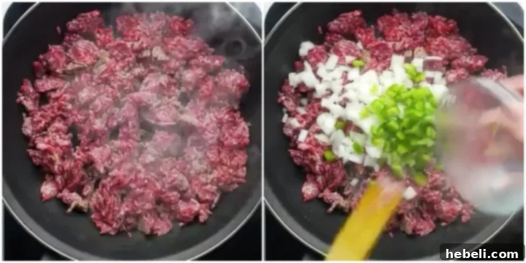 Ground beef mixture being cooked with onions and green peppers, forming the base of the sloppy joe filling.