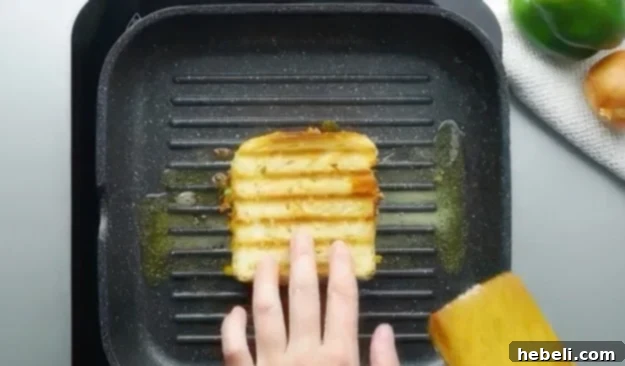 Cooking the Sloppy Joe Grilled Cheese sandwich on a griddle, browning it to a perfect golden crisp.
