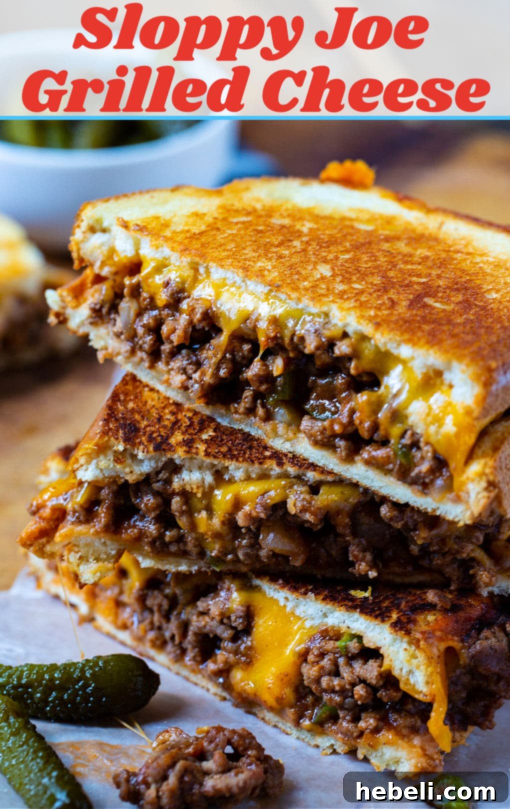 Sloppy Joe Grilled Cheese halves ready to be enjoyed on a serving board.