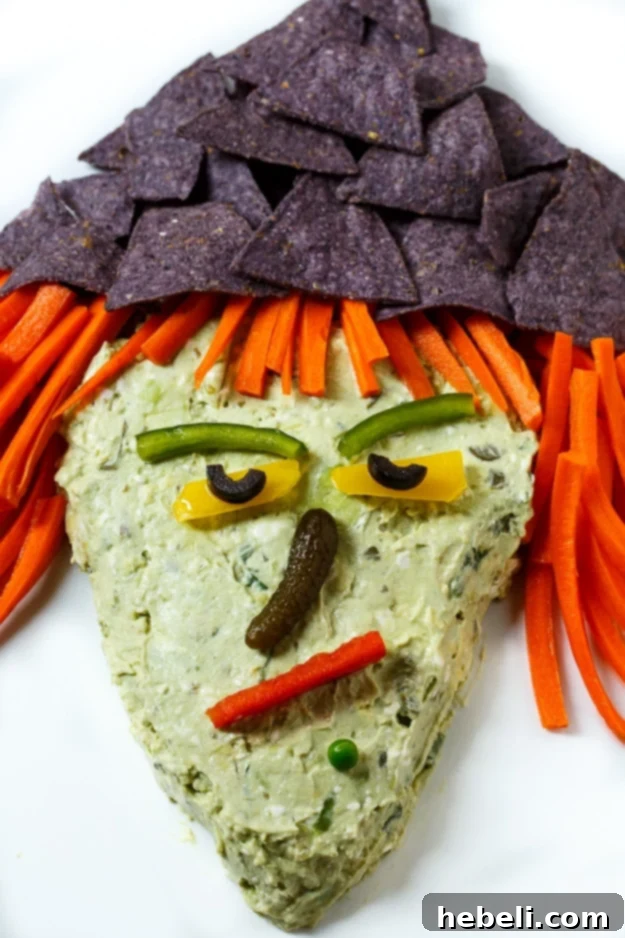 Witch's Brew Guacamole 3 Close-up of Witch Guacamole Dip, highlighting the creamy texture and fresh ingredients used for facial features.