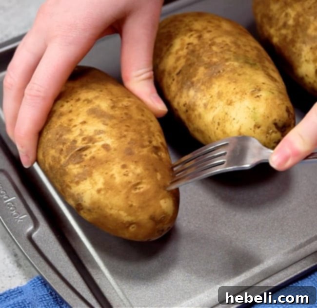 Piercing the potatoes with a fork before baking.
