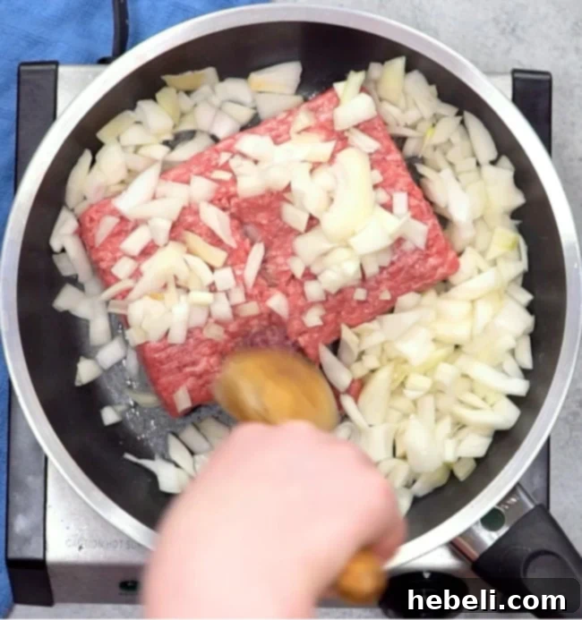 Cooking ground beef and onion in a skillet.