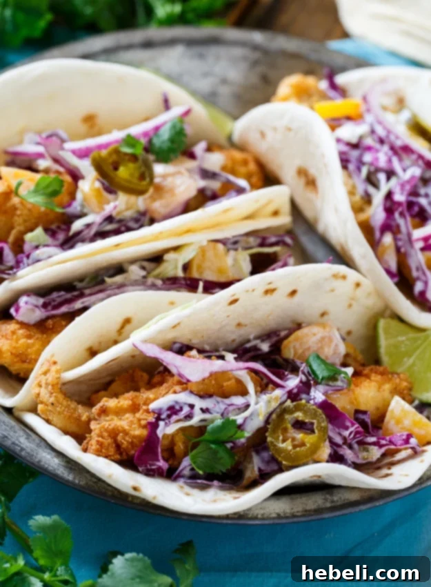 Southern Catfish Tacos with Jalapeno Peach Slaw, highlighting the crispy catfish and fresh slaw.